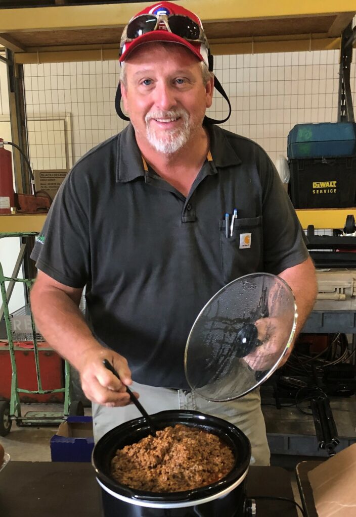 Carl cooking chilli at office ()